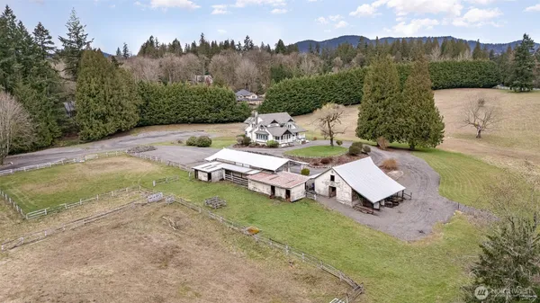 an aerial view of a house with garden space and trees
