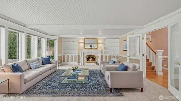 a living room with furniture large window and rug