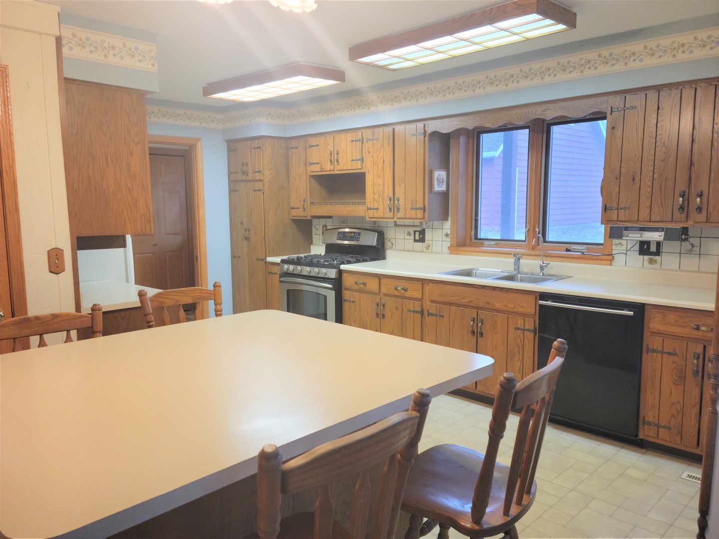 18715 Hebron Road Harvard, IL 60033 - Photo 20 of 54 a kitchen with a table chairs sink and cabinets