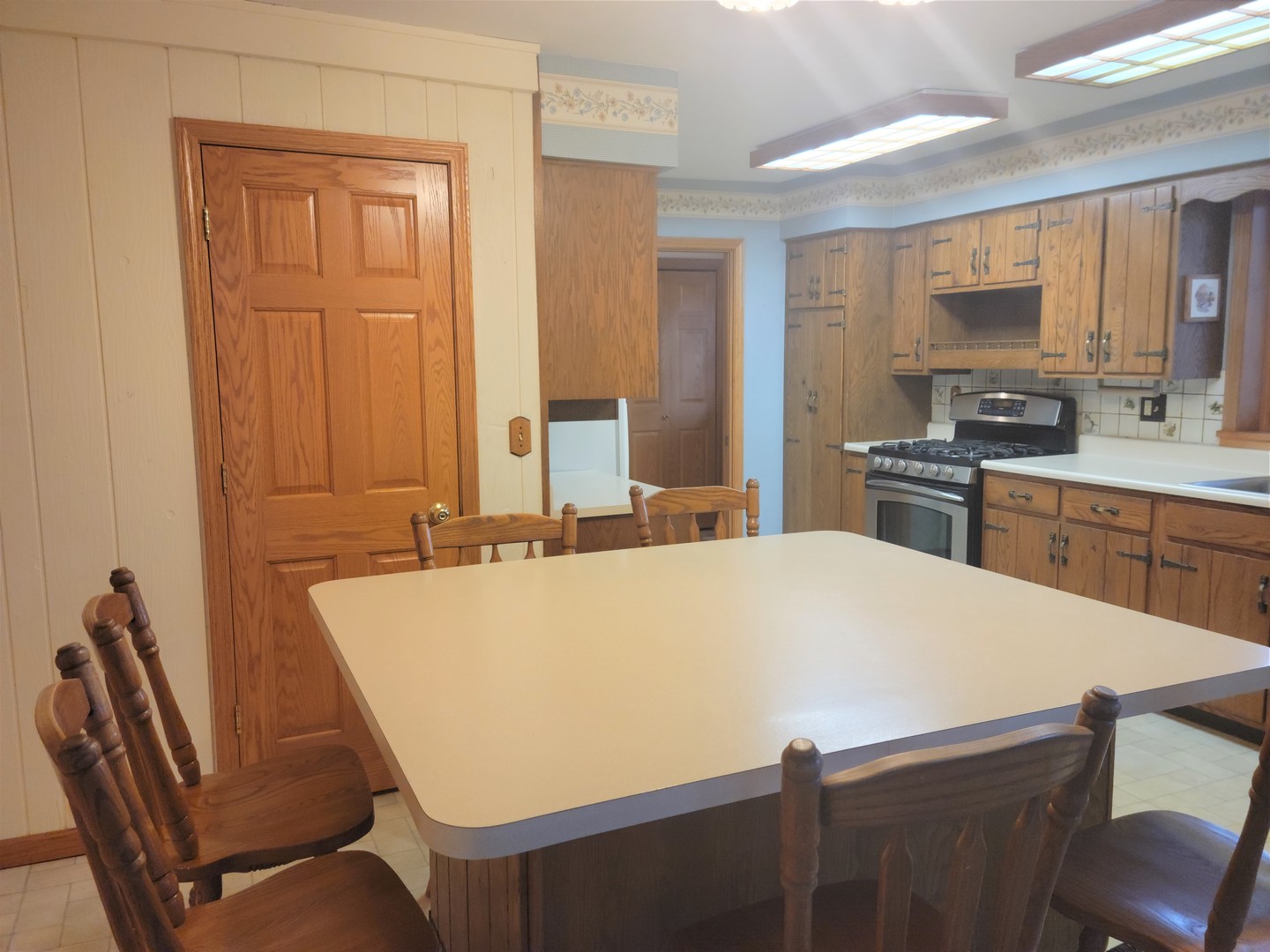18715 Hebron Road Harvard, IL 60033 - Photo 21 of 54 a large white kitchen with a table and chairs