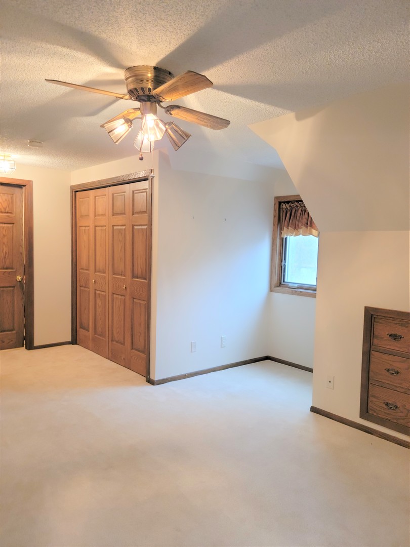 18715 Hebron Road Harvard, IL 60033 - Photo 40 of 54 an empty room with closet and fan
