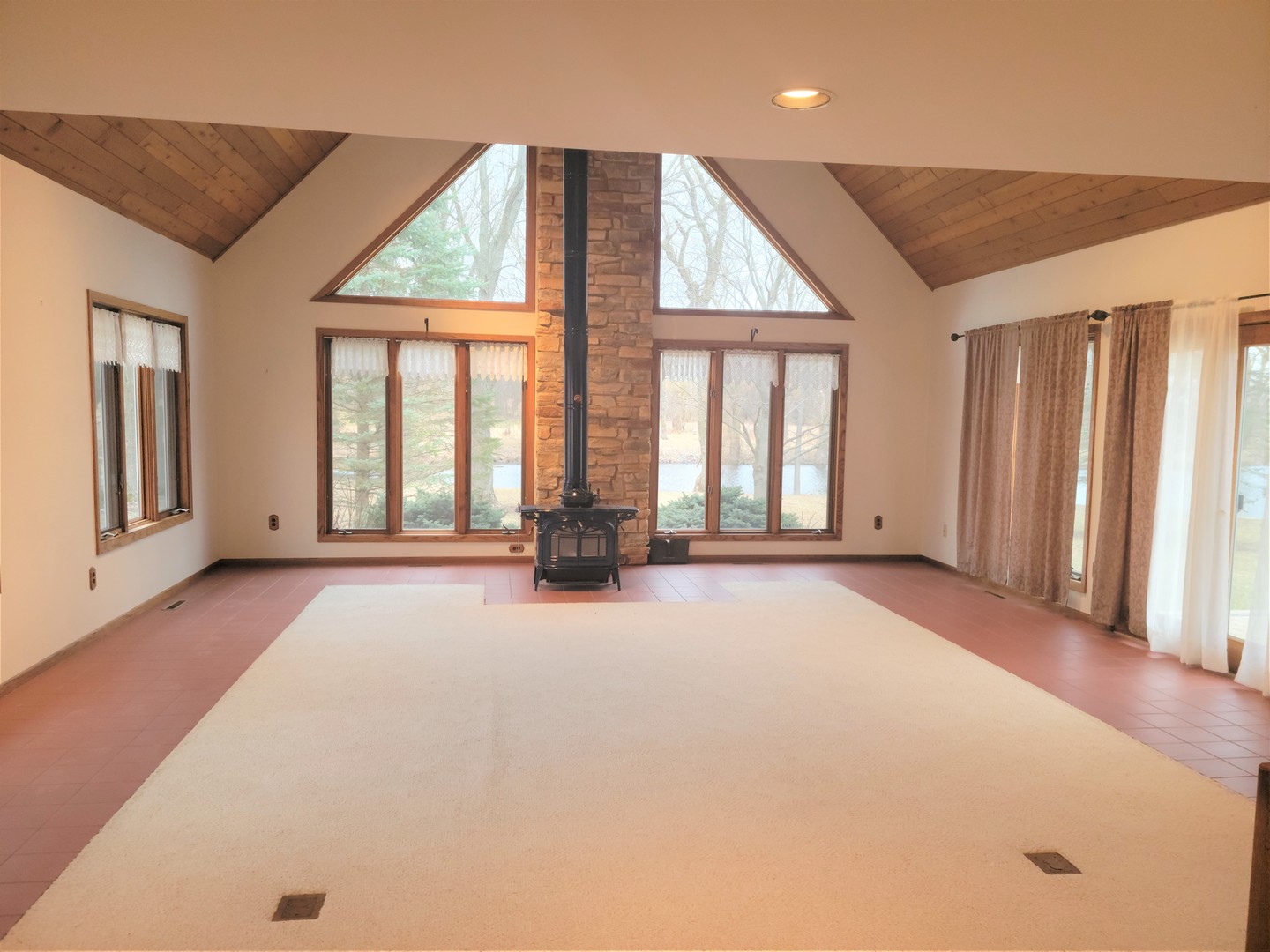 18715 Hebron Road Harvard, IL 60033 - Photo 8 of 54 a view of an empty room with a fireplace and windows