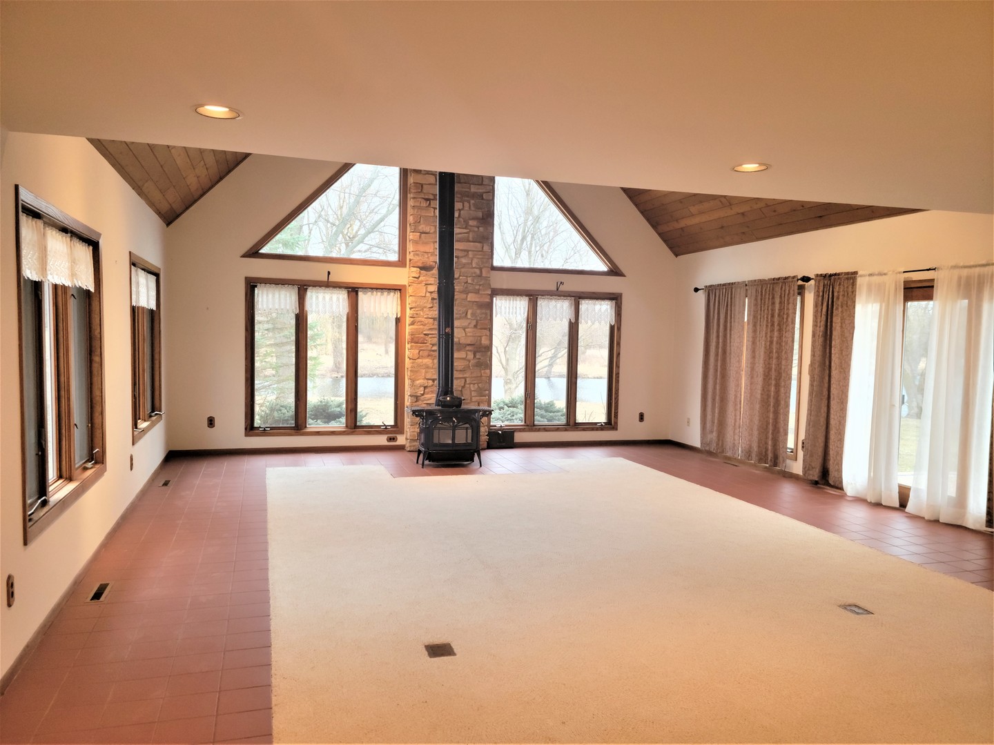 18715 Hebron Road Harvard, IL 60033 - Photo 9 of 54 a view of an empty room with a fireplace and a large window