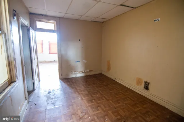 a view of an empty room and a window