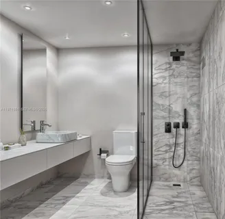 a bathroom with a granite countertop sink a toilet and shower