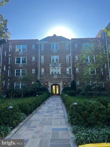a view of a big yard in front of a brick building