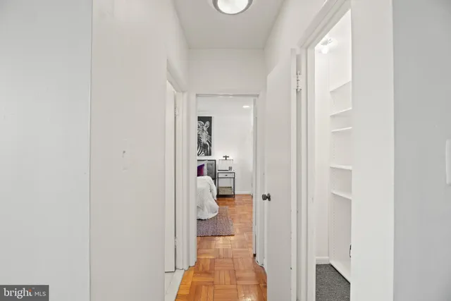 a view of a hallway with white walls and stairs