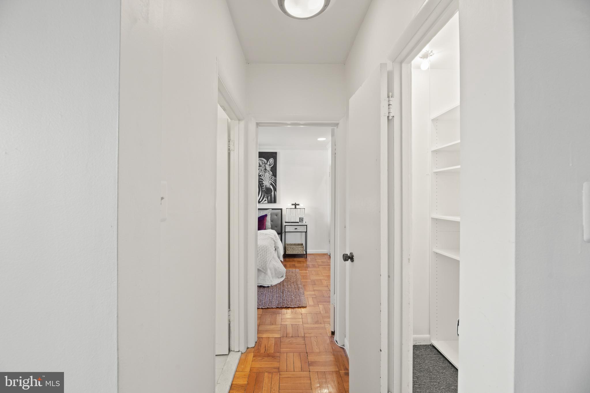 3051 Idaho Avenue Northwest, Unit 119 Washington, DC 20016 - Photo 14 of 36 a view of a hallway with white walls and stairs