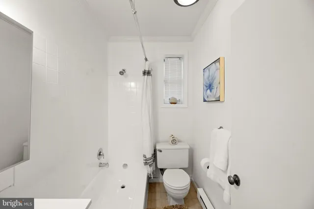 a white toilet sitting next to a bathroom sink