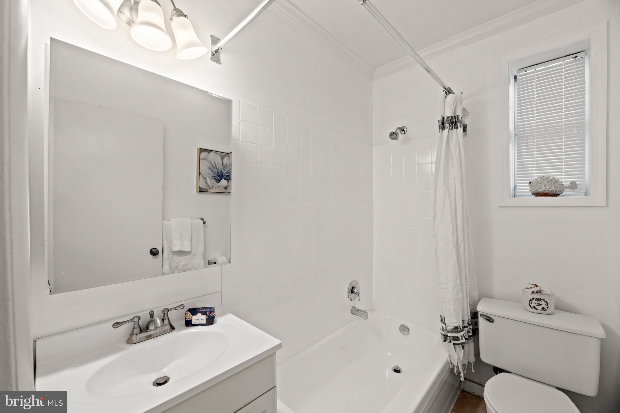 3051 Idaho Avenue Northwest, Unit 119 Washington, DC 20016 - Photo 17 of 36 a bathroom with a sink a toilet and shower