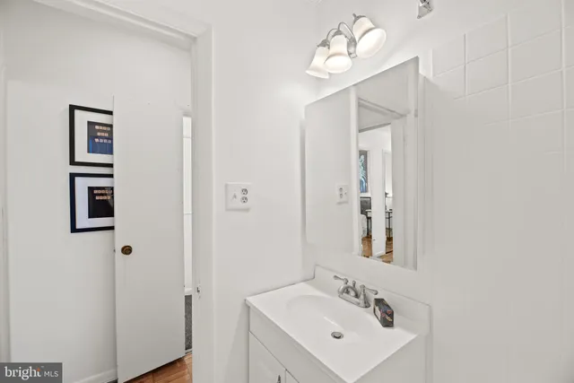a bathroom with a sink a mirror and a window