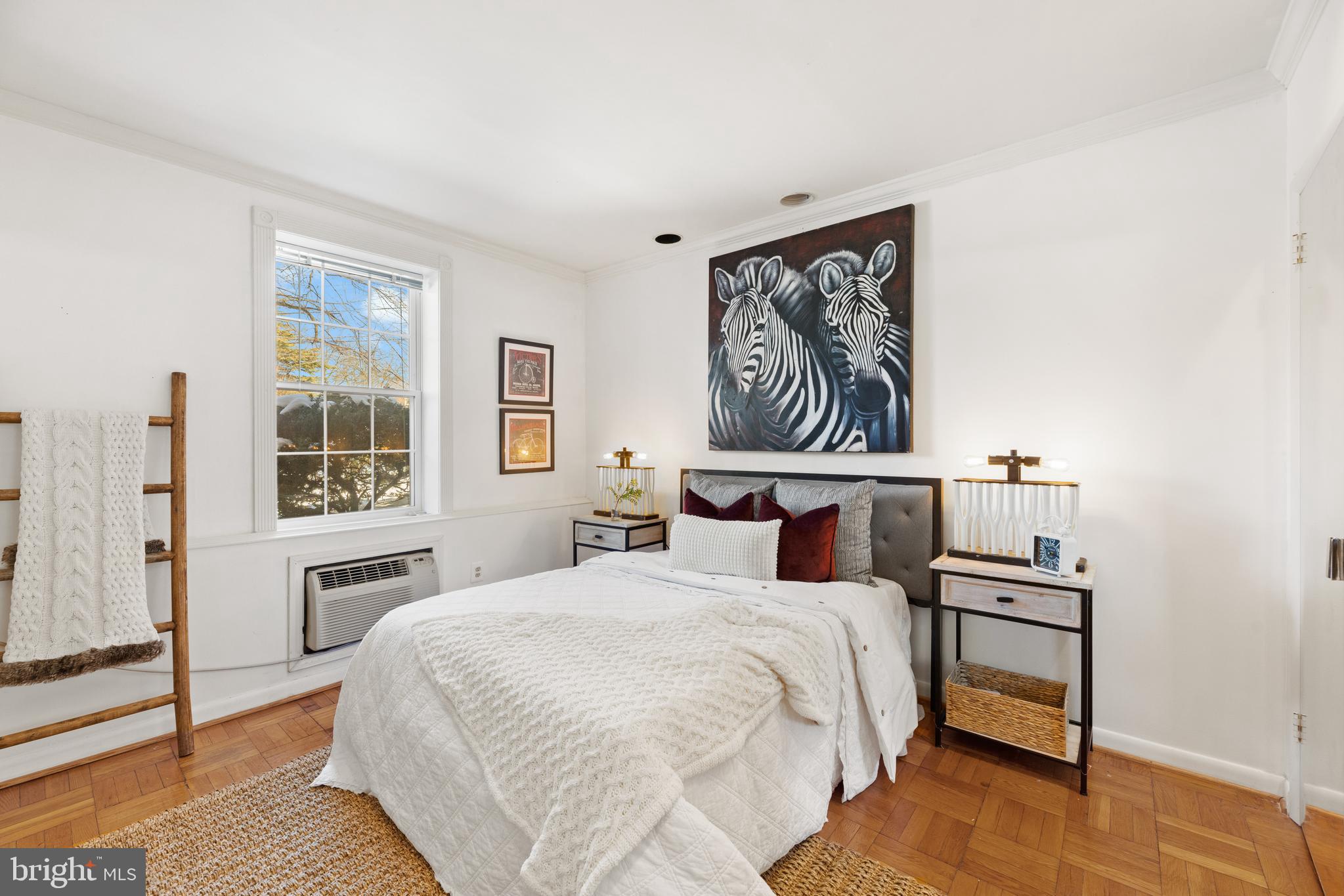 3051 Idaho Avenue Northwest, Unit 119 Washington, DC 20016 - Photo 20 of 36 a bedroom with a large bed and a window