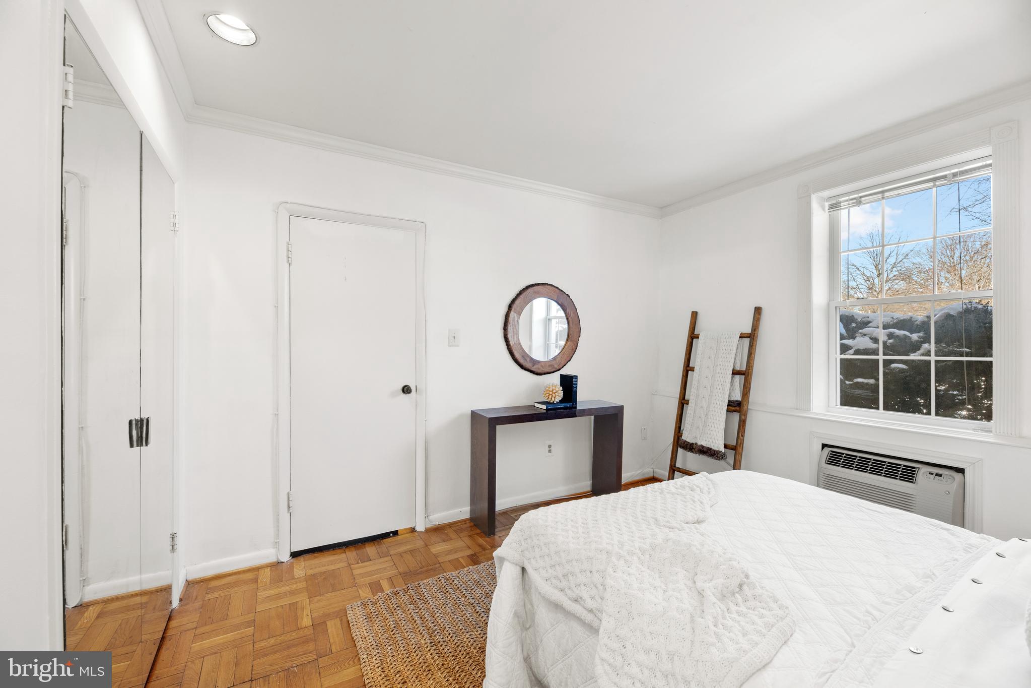 3051 Idaho Avenue Northwest, Unit 119 Washington, DC 20016 - Photo 25 of 36 a bedroom with a bed and a window