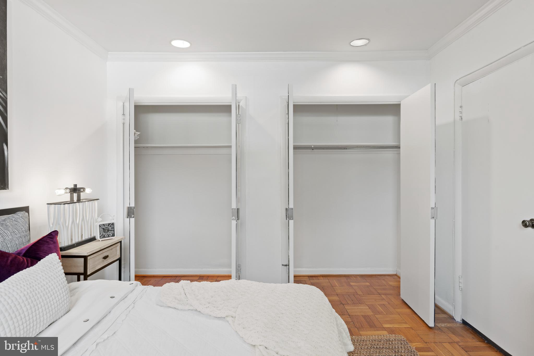 3051 Idaho Avenue Northwest, Unit 119 Washington, DC 20016 - Photo 27 of 36 a bedroom with a bed and a lamp on the dresser