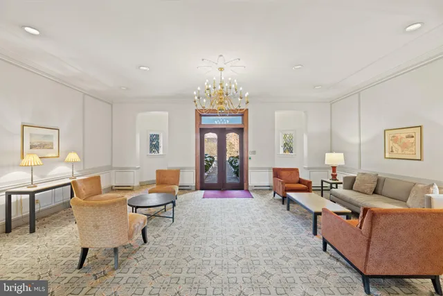 a living room with furniture chandelier and a chandelier