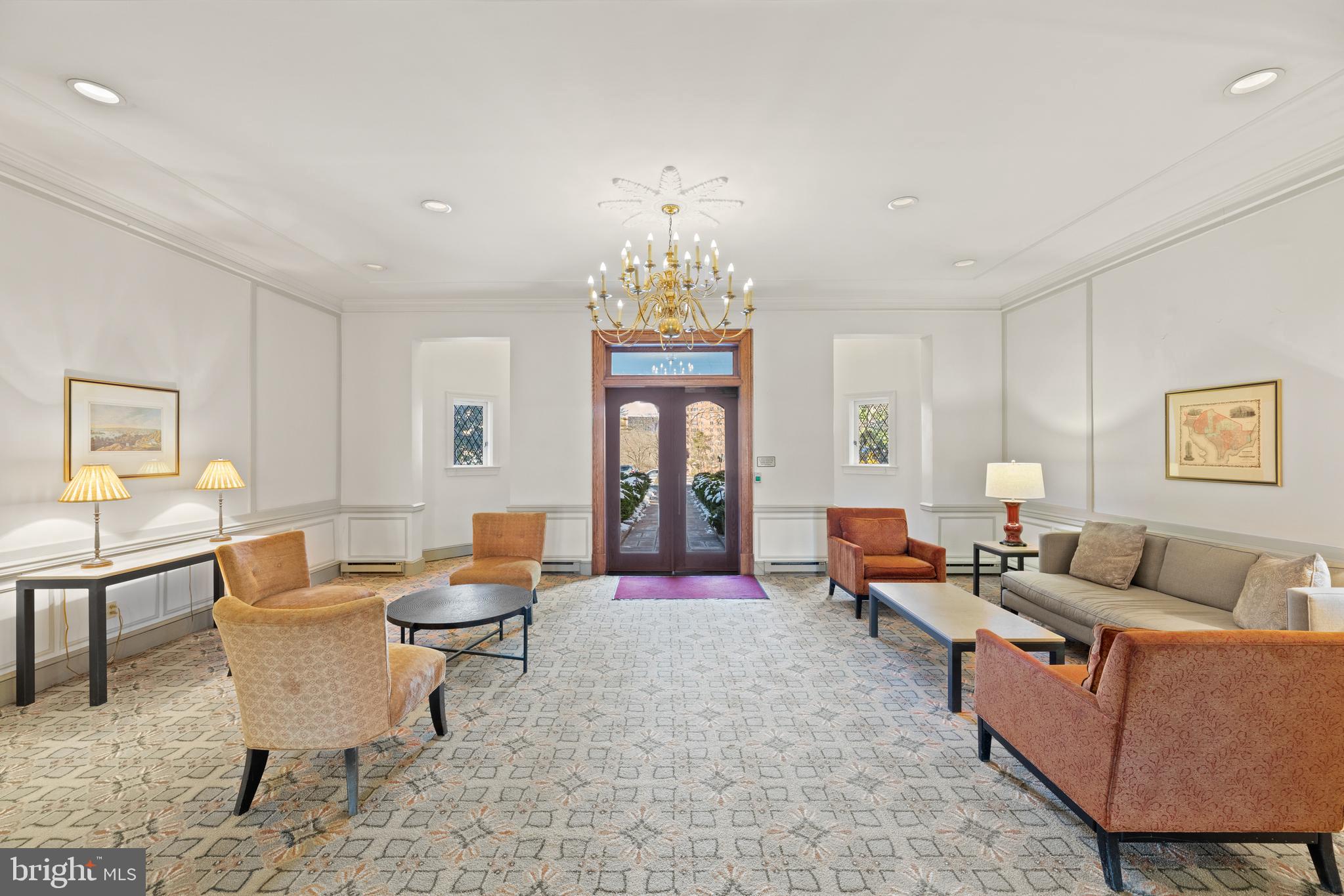 3051 Idaho Avenue Northwest, Unit 119 Washington, DC 20016 - Photo 30 of 36 a living room with furniture a chandelier and a rug