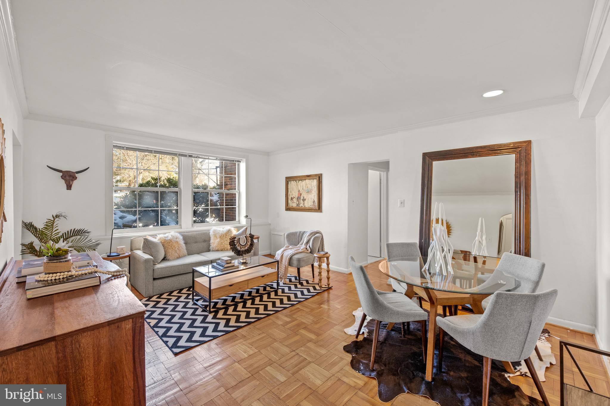 3051 Idaho Avenue Northwest, Unit 119 Washington, DC 20016 - Photo 3 of 36 a living room with furniture and a table