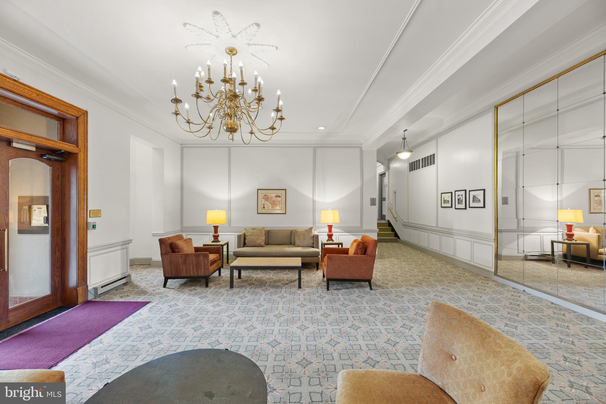 3051 Idaho Avenue Northwest, Unit 119 Washington, DC 20016 - Photo 31 of 36 a living room with furniture chandelier and a chandelier