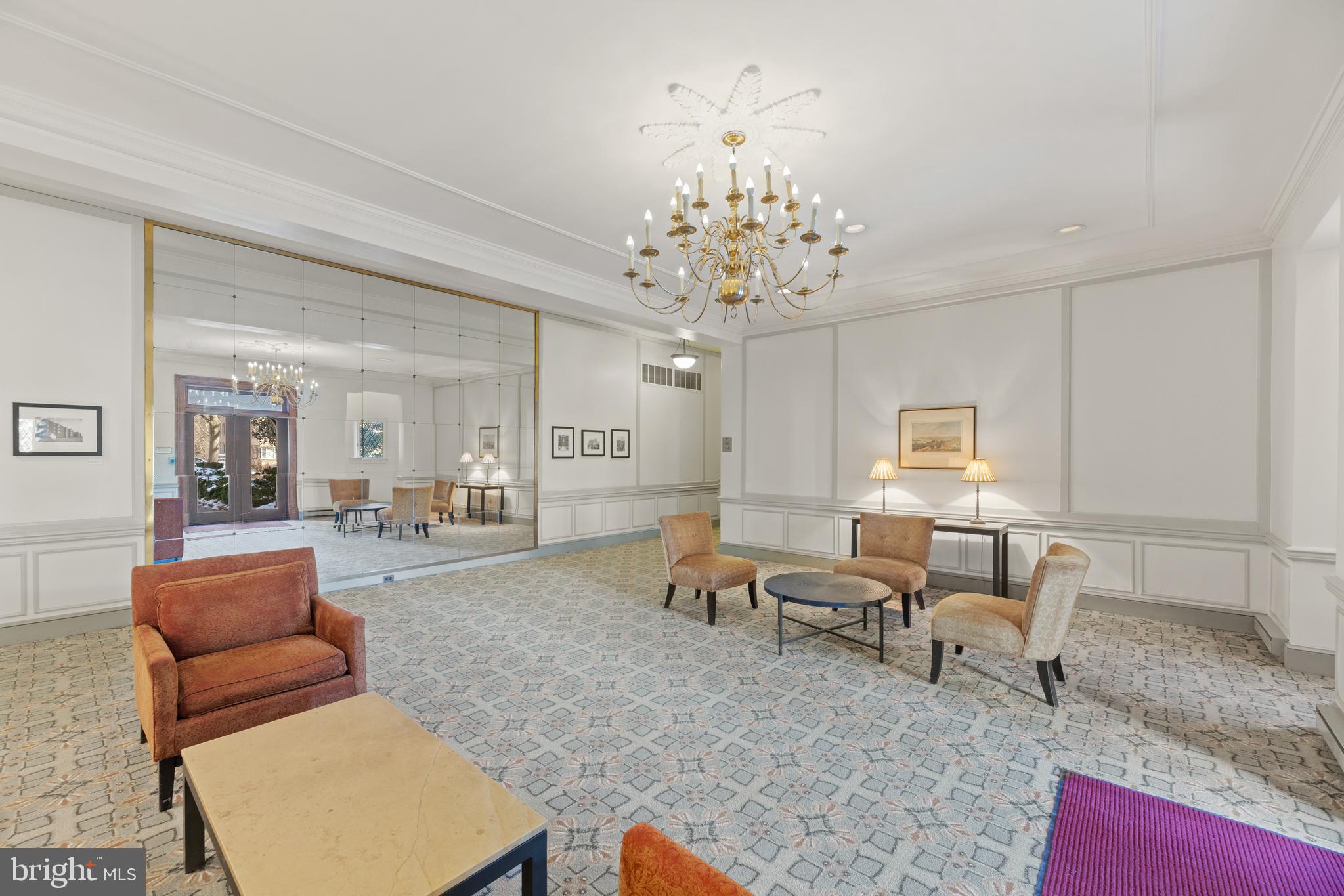 3051 Idaho Avenue Northwest, Unit 119 Washington, DC 20016 - Photo 32 of 36 a living room with furniture chandelier and a rug