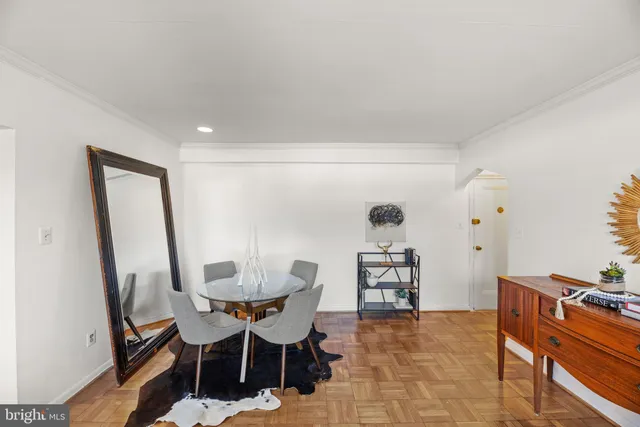 a dining room with furniture and wooden floor
