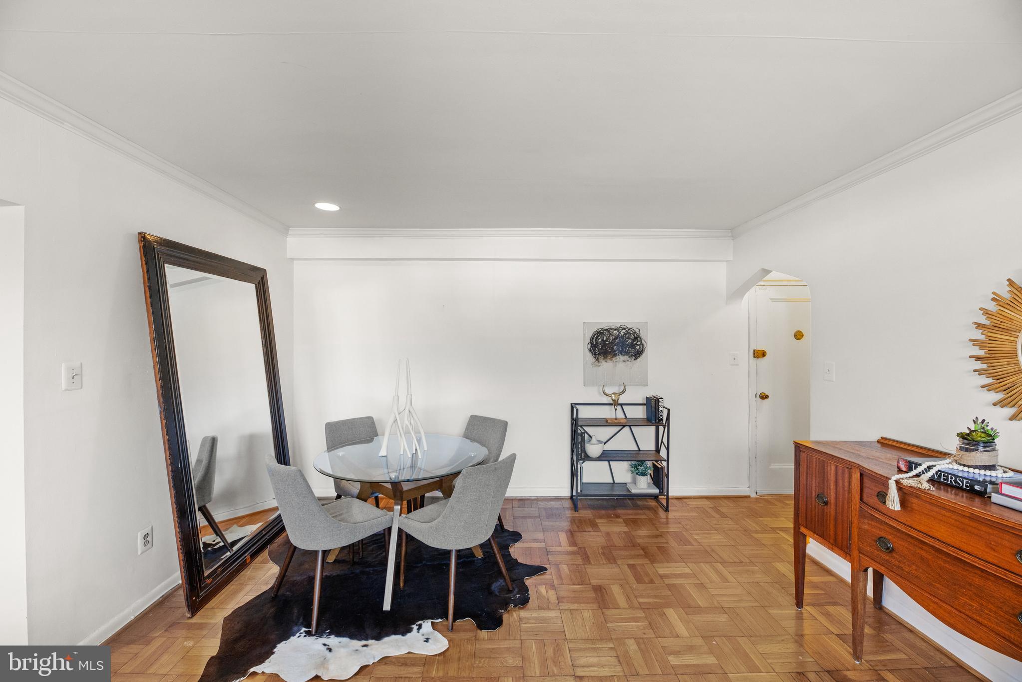 3051 Idaho Avenue Northwest, Unit 119 Washington, DC 20016 - Photo 6 of 36 a dining room with furniture and wooden floor