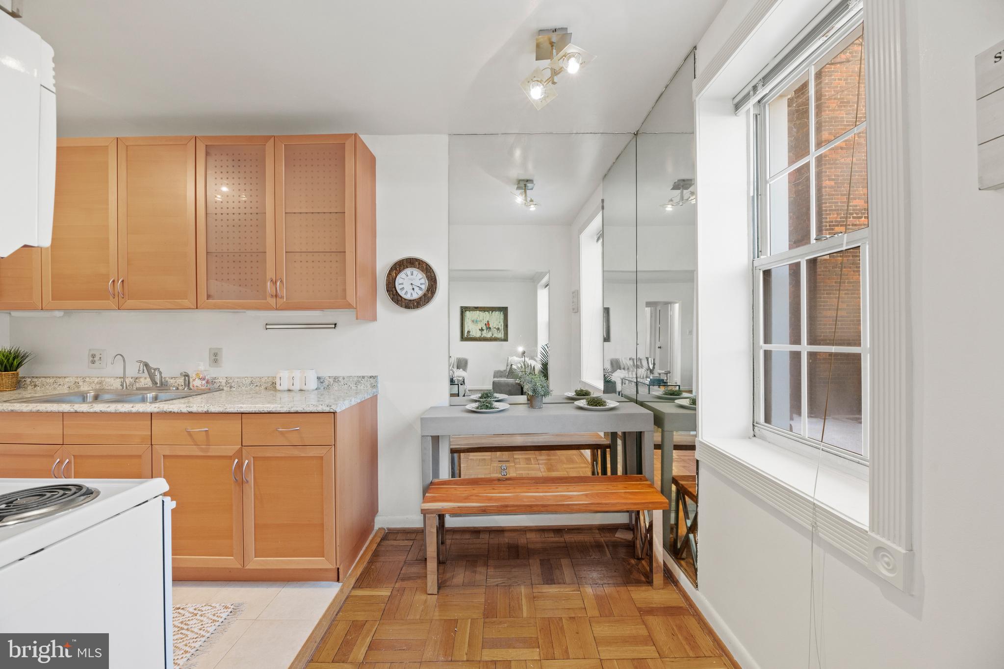3051 Idaho Avenue Northwest, Unit 119 Washington, DC 20016 - Photo 8 of 36 a view of a kitchen with cabinets and outdoor seating