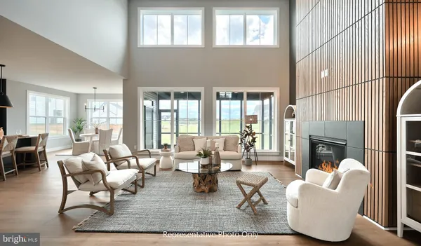 a living room with furniture a fireplace and a large window
