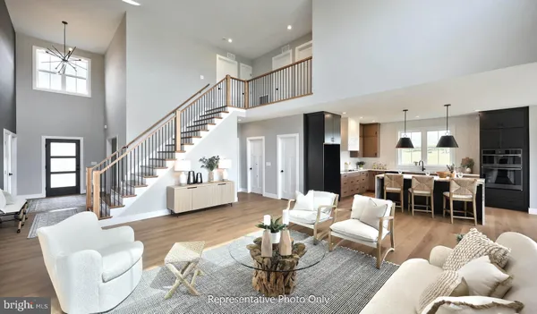 a living room with fireplace furniture and a wooden floor