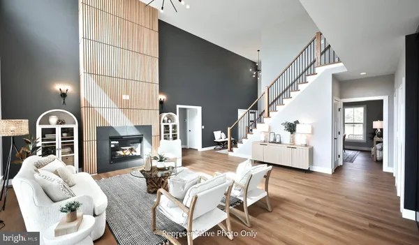 a kitchen with stainless steel appliances granite countertop a sink a stove a refrigerator and island with wooden floor