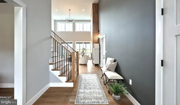 a view of entryway and hall with wooden floor