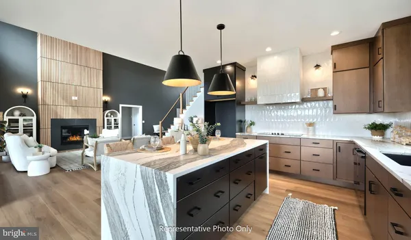a view of a kitchen with granite countertop a sink and a window