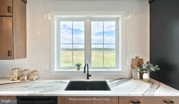 a kitchen with a stove a sink a dining table and chairs