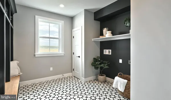 a living room with a rug and wooden floor