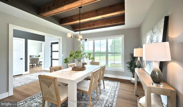 a dining room with furniture and wooden floor