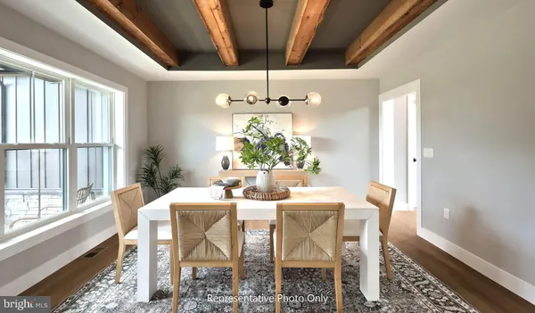 a dining room with furniture a chandelier and window