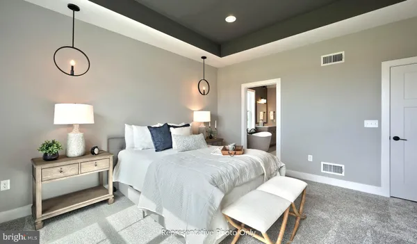 a bedroom with a bed and large windows