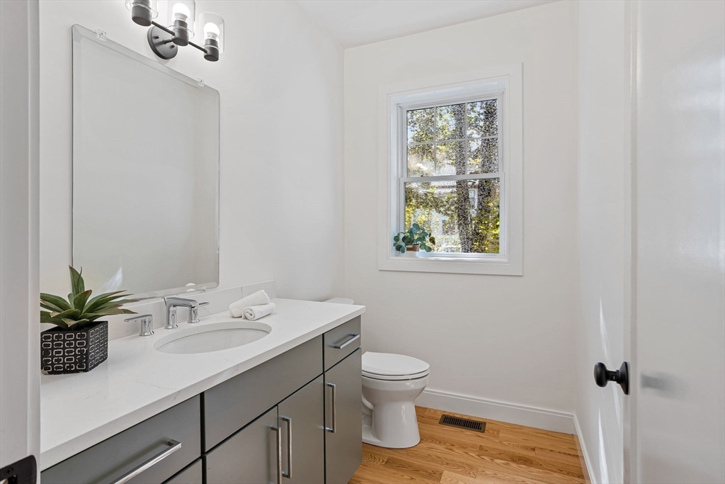 75 Franklin Street, Unit 2 Arlington, MA 02474 - Photo 13 of 38 a bathroom with a sink toilet and a mirror