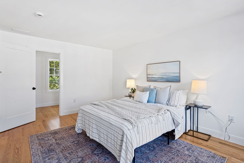 75 Franklin Street, Unit 2 Arlington, MA 02474 - Photo 22 of 38 a bedroom with a bed and a lamp on table