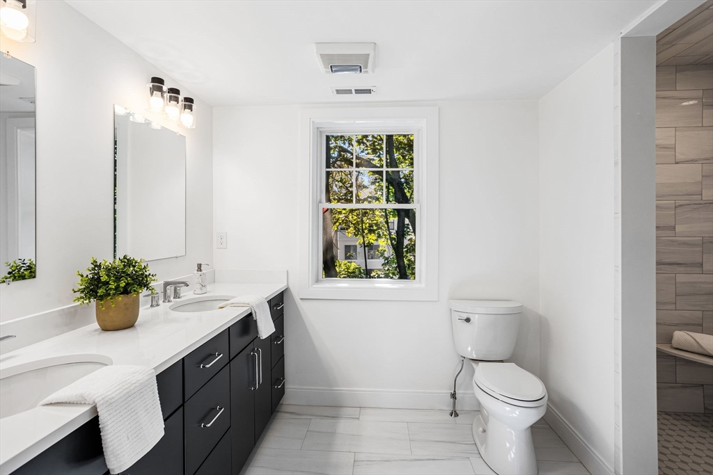 75 Franklin Street, Unit 2 Arlington, MA 02474 - Photo 23 of 38 a bathroom with a sink toilet and window