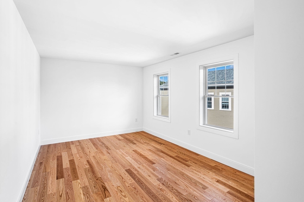 75 Franklin Street, Unit 2 Arlington, MA 02474 - Photo 24 of 38 an empty room with windows