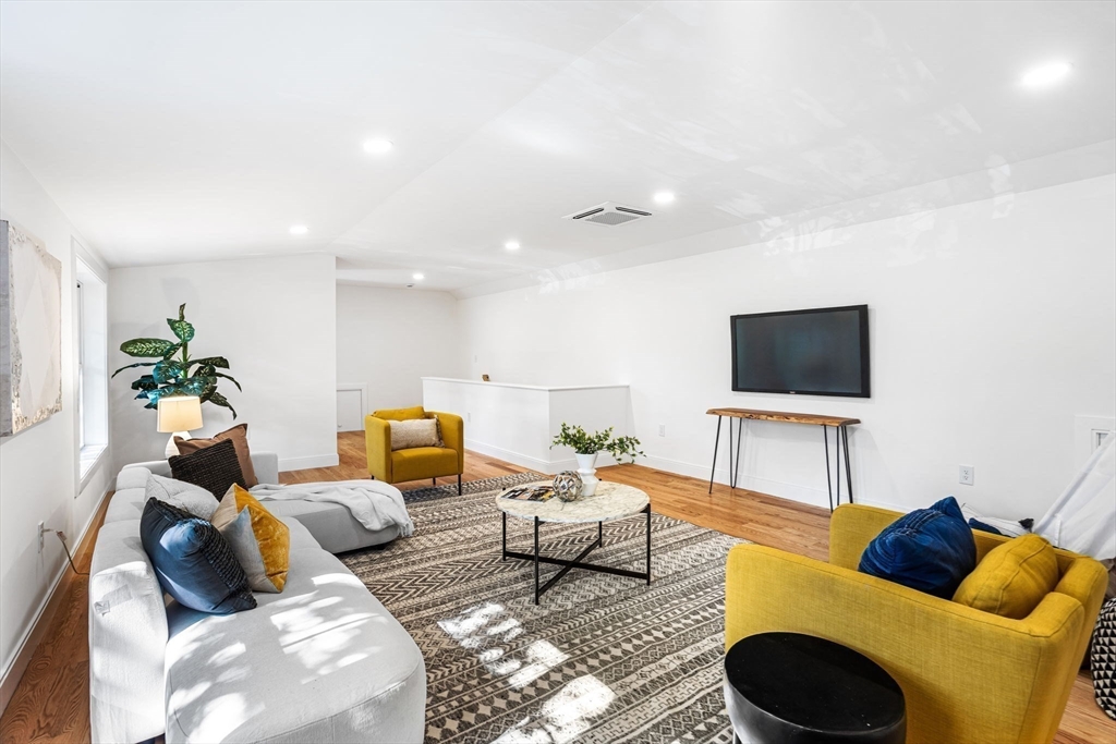 75 Franklin Street, Unit 2 Arlington, MA 02474 - Photo 27 of 38 a living room with furniture and a flat screen tv
