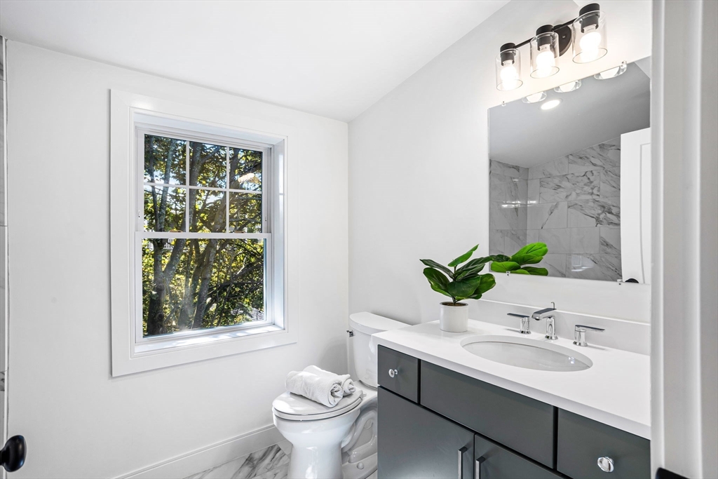 75 Franklin Street, Unit 2 Arlington, MA 02474 - Photo 29 of 38 a bathroom with a sink toilet and mirror