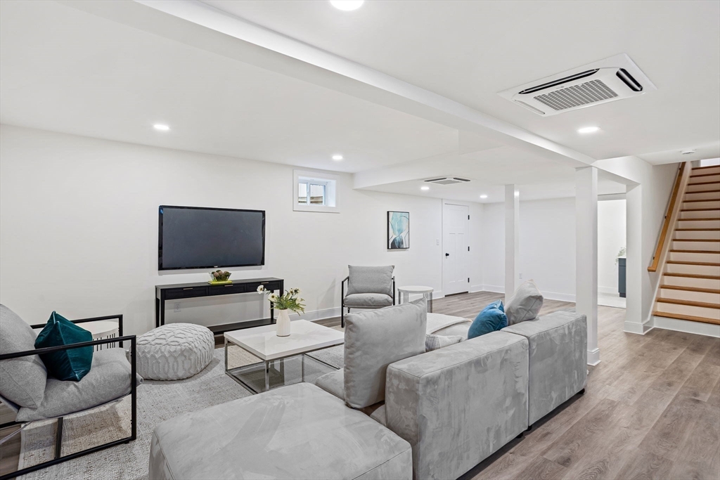 75 Franklin Street, Unit 2 Arlington, MA 02474 - Photo 31 of 38 a living room with furniture and a flat screen tv