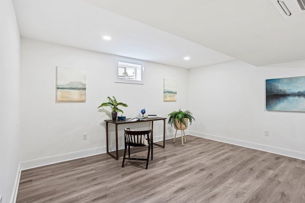 75 Franklin Street, Unit 2 Arlington, MA 02474 - Photo 32 of 38 a workspace with furniture and wooden floor