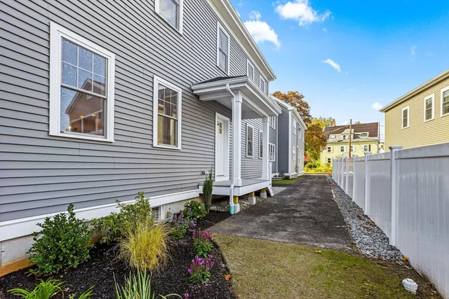 a backyard of a house with flower plants