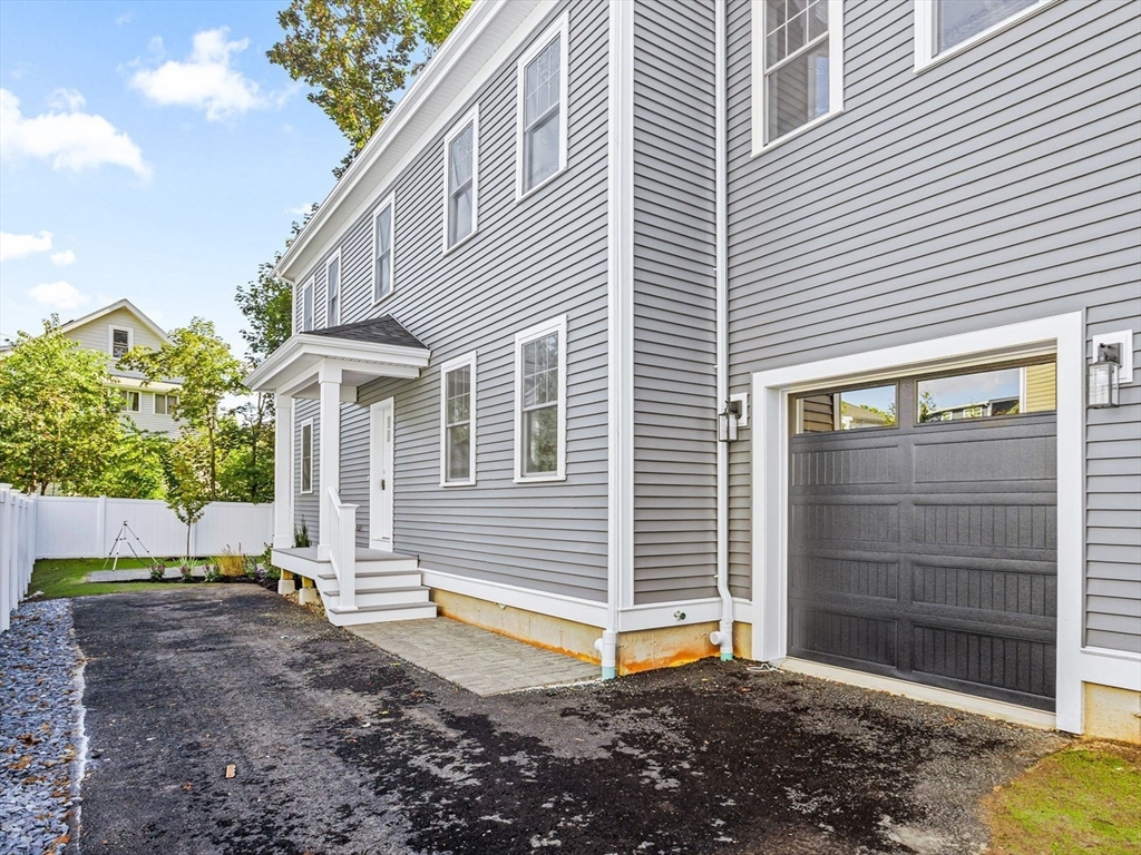 75 Franklin Street, Unit 2 Arlington, MA 02474 - Photo 37 of 38 a front view of a house with a yard