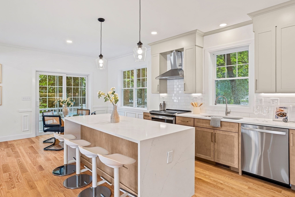 75 Franklin Street, Unit 2 Arlington, MA 02474 - Photo 6 of 38 a kitchen with a sink stove and wooden floor
