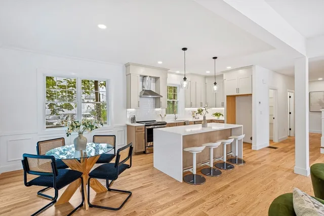 a large kitchen with a table and chairs