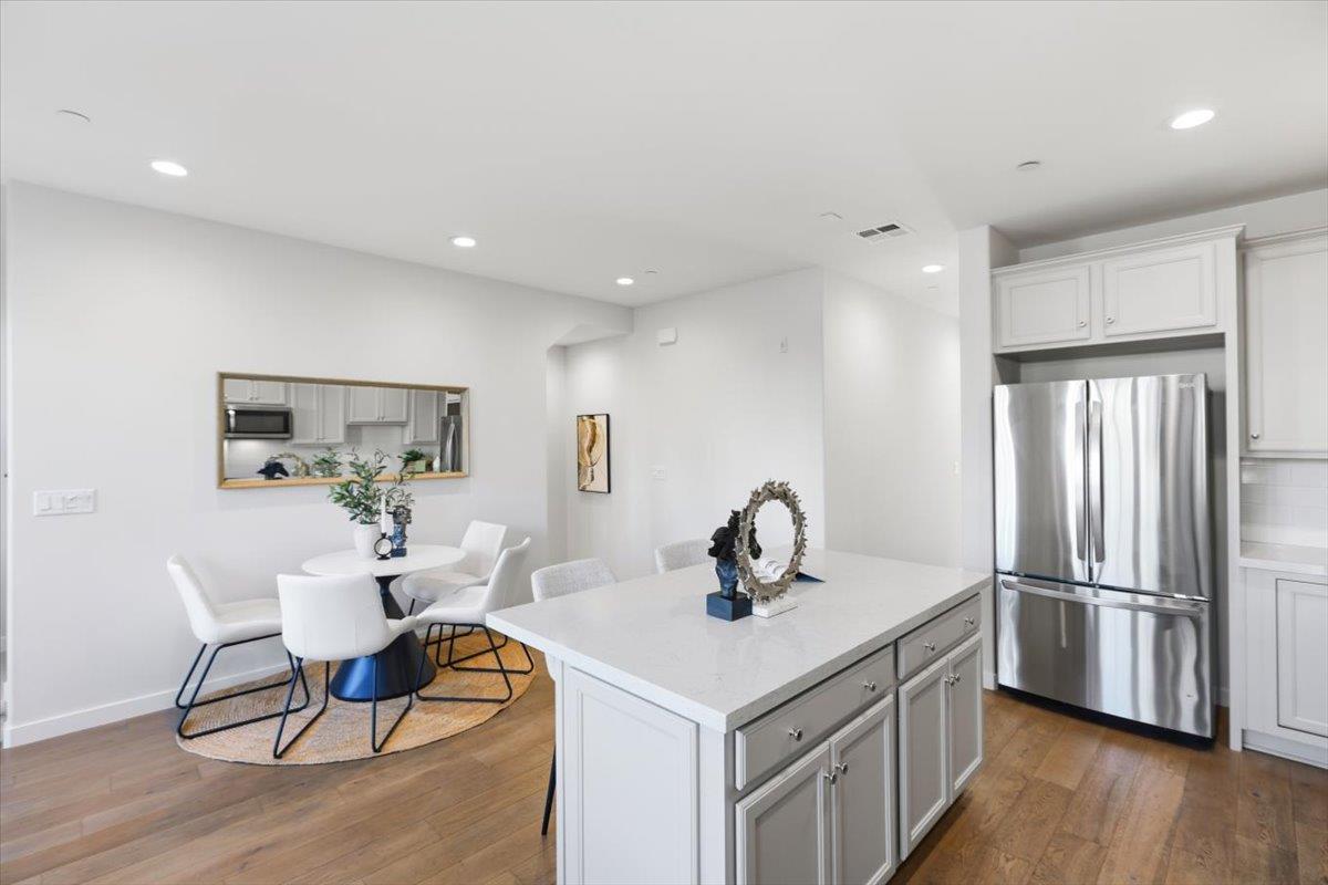 1910 Joshua Tree Circle Milpitas, CA 95035 - Photo 6 of 43 a kitchen with stainless steel appliances refrigerator sink dining table and chairs