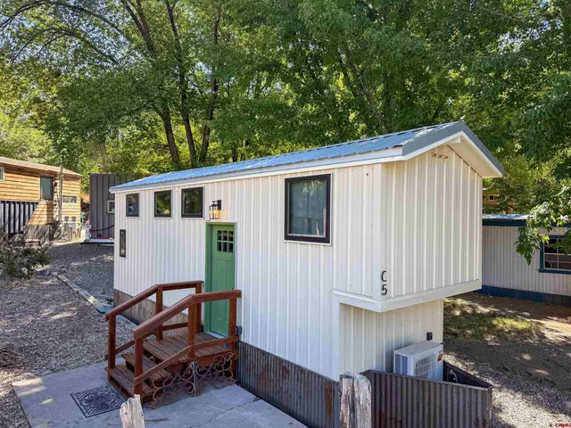 a view of backyard with a deck and furniture